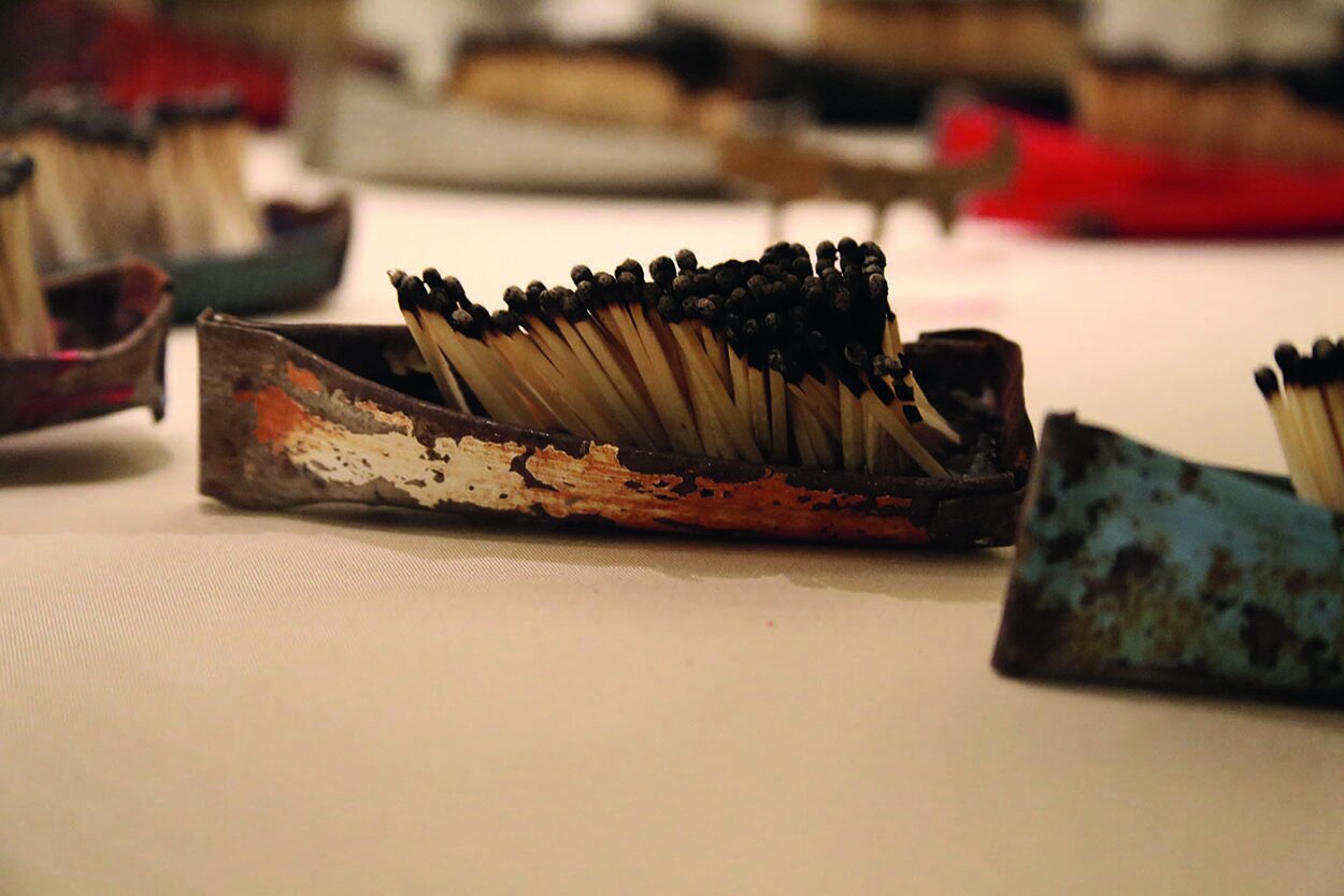 Issam Kourbaj, Dark Water, Burning World , 2017. Bicycle mudguards and burnt matches. H: 3 cm W: 5 cm L: 14 cm (average). Reproduced by permission of the artist.
