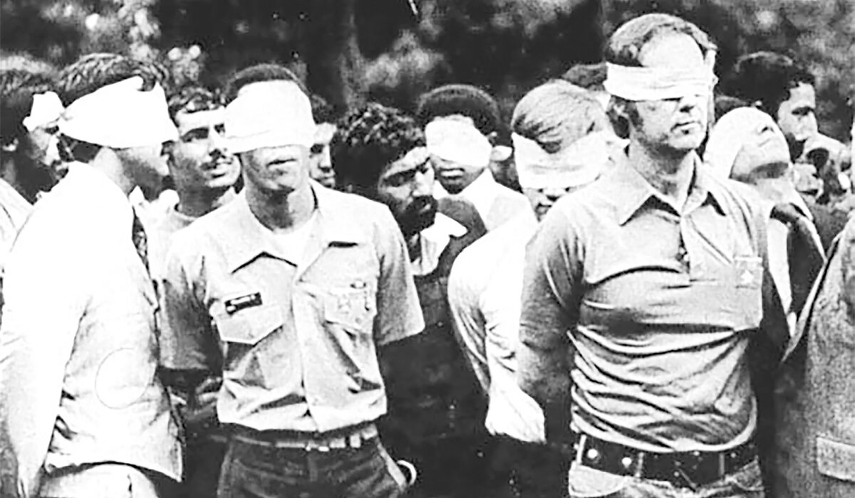 Blindfolded U.S. hostages and their Iranian captors outside the U.S. embassy in Tehran, Iran, 1979. (U.S. Army/Handout via Reuters).