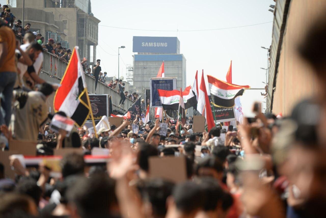 Students march in Baghdad to celebrate the first anniversary of the October revolution (Photo: Mujtaba Suhail courtesy  MEE )