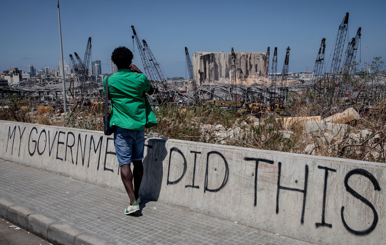 A man taking a photograph of the destroyed Beirut port, Lebanon, August 16, 2020 [Chris McGrath, Getty Images]