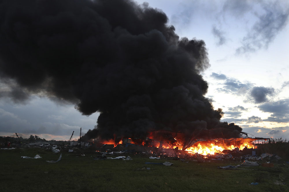 Black smoke and flames rise from a burning warehouse, hit by Israeli strikes, at an industrial district, in the southern coastal town of Ghazieh, Lebanon, February 19, 2024. (photo Mohammed Zaatari courtesy AP)