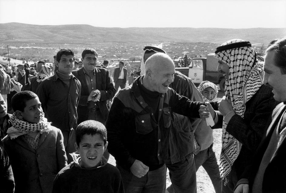 Jean Genet, center, visits a Palestinian refugee camp near Amman, Jordan, 1971 (photo Bruno Barbey).