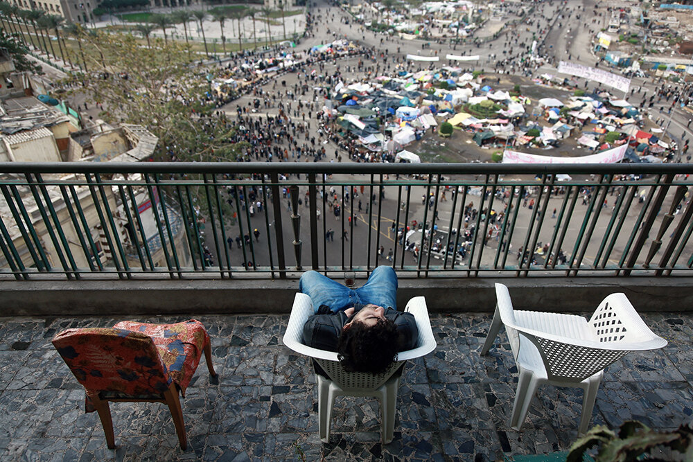 An exhausted young activist catches a nap at dawn, following the conclusion of the battle.