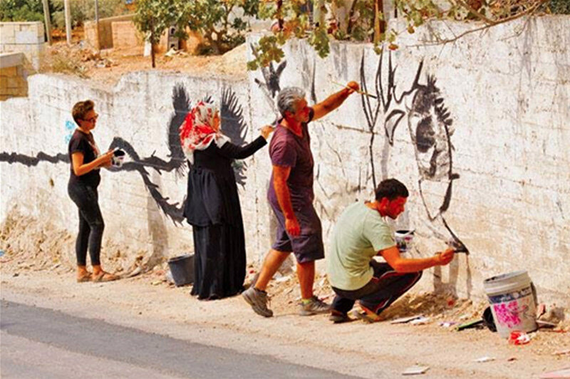 Letelier, second from right, works with the Bil'in community.