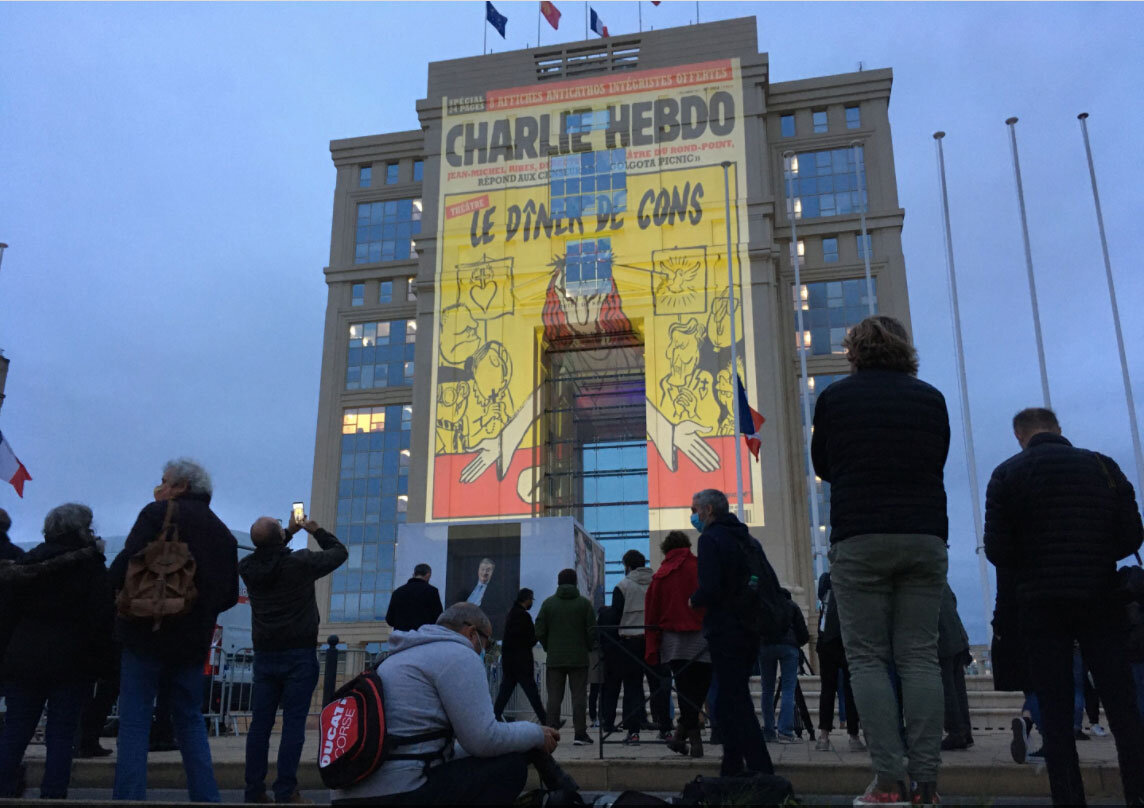 Montpellier's city hall  projects images of slain schoolteacher Samuel Paty and satirical cartoons he shared with his students (Photo: Vincent Pereira/Midi-Libre)