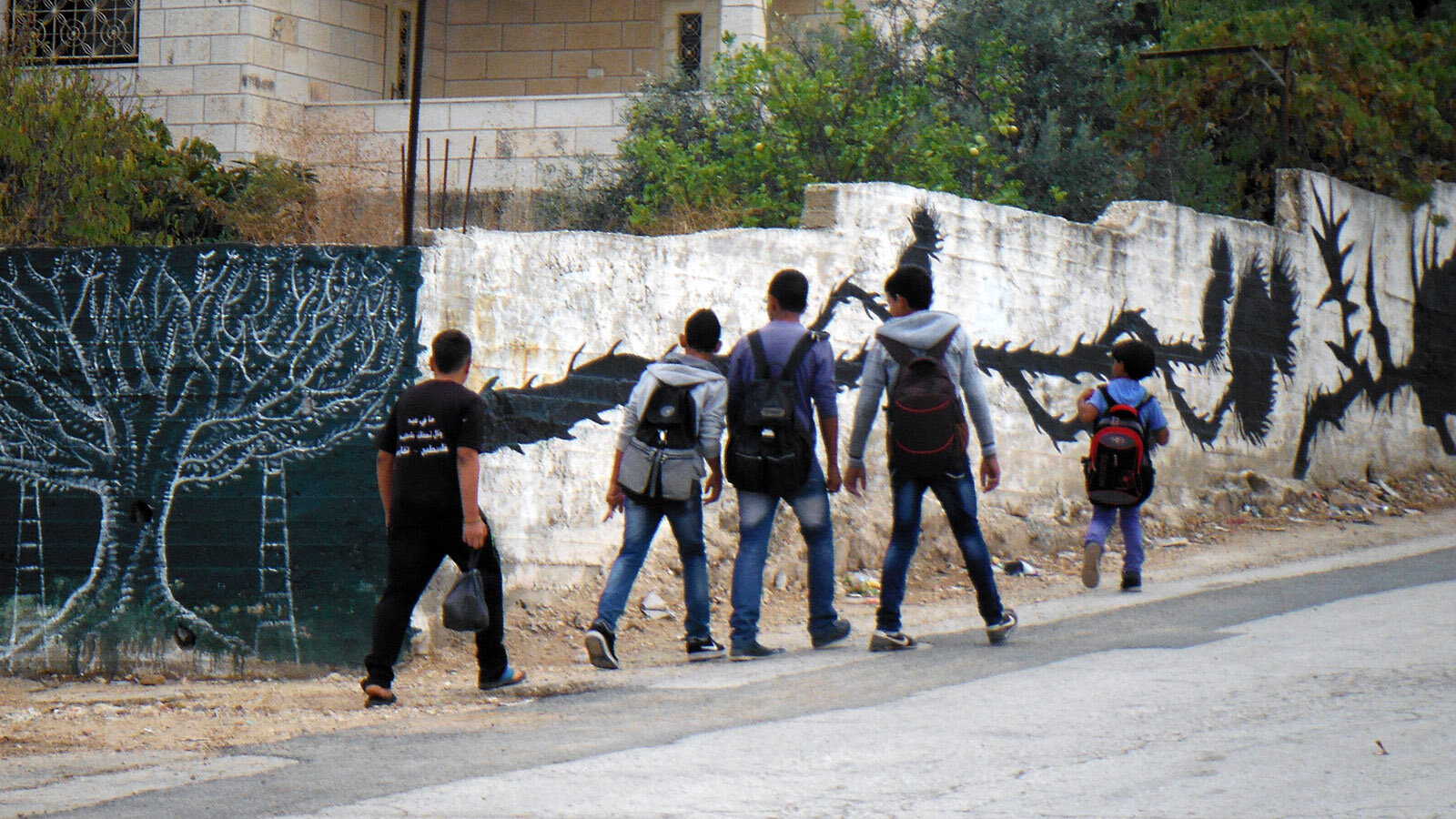 Bil'in kids on their way to school pass the murals each day.