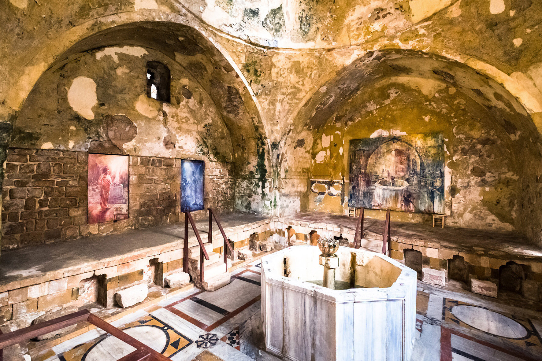 Hammam Al Jadeed entrance hall prior to restauration, with paintings by Tom Young (photo courtesy Karim Sakr).