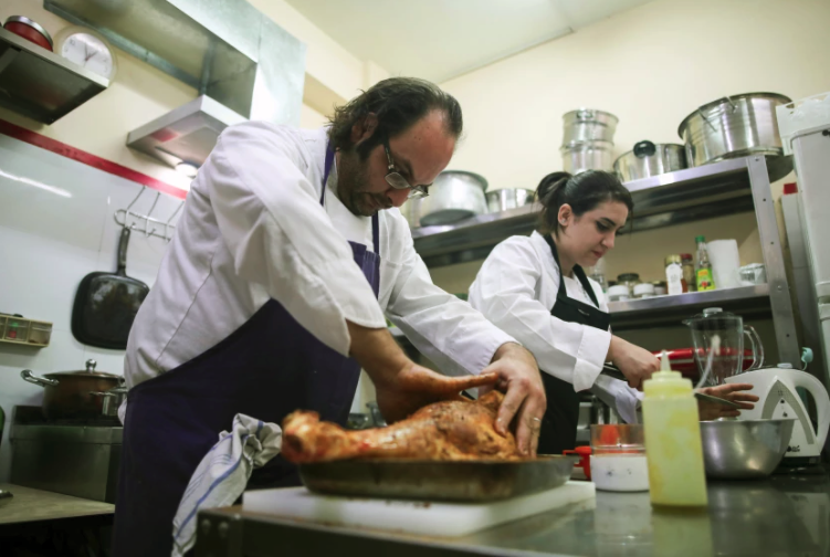 Chef Fadi Kattan and Fateen Halahla prepare dishes at Fawda (Photo Corinna Kern, LA Times)