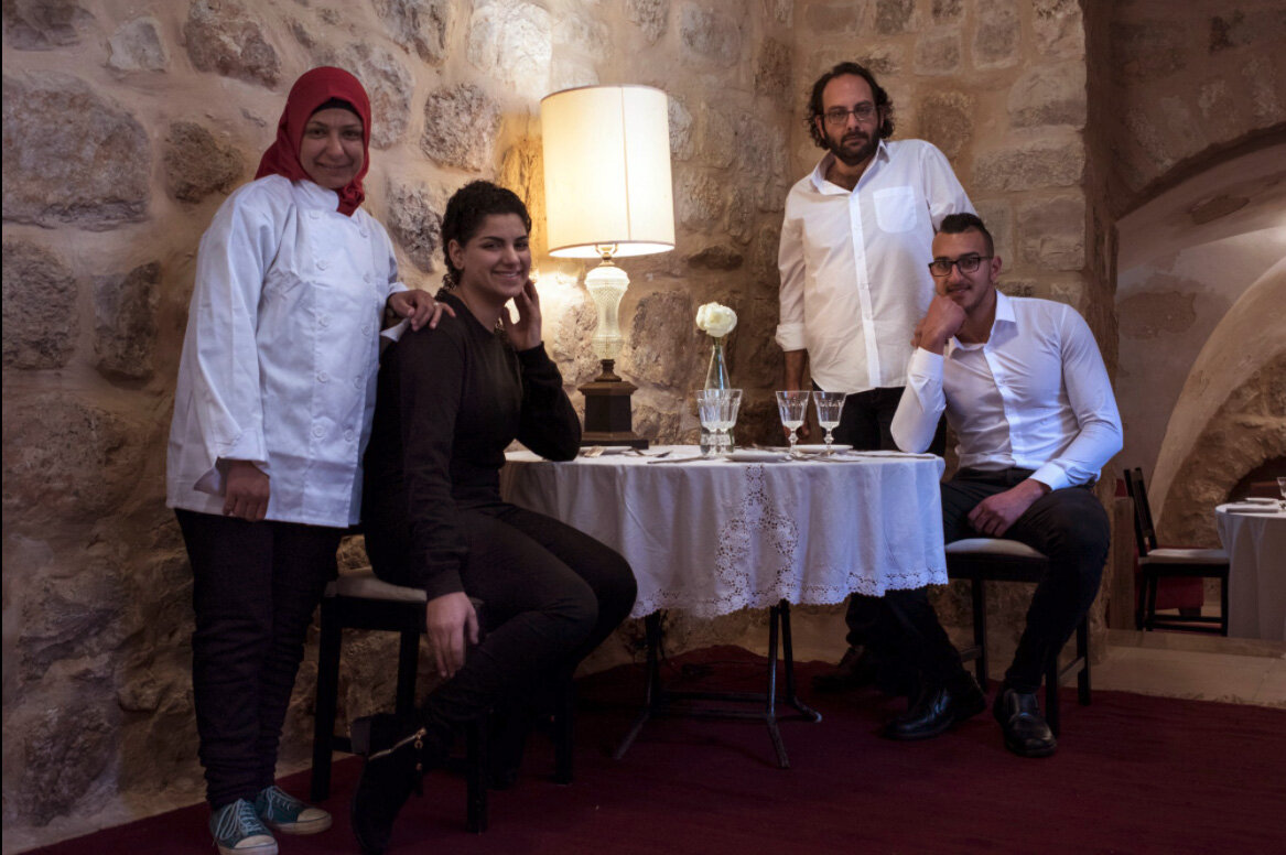 Chef Fadi Kattan (second from right) and the staff at Fawda restaurant in Bethlehem.