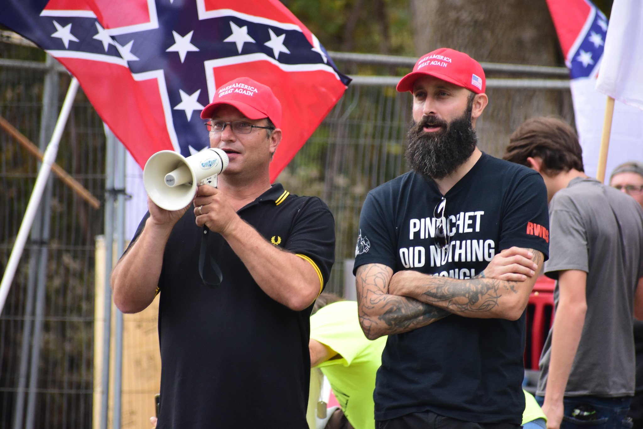 Proud Boys Jay Thaxton and Jeremy Bertino, who showed up at a rally in a Pinochet tee-shirt w/ the acronym for Right Wing Death Squad on his sleeve.