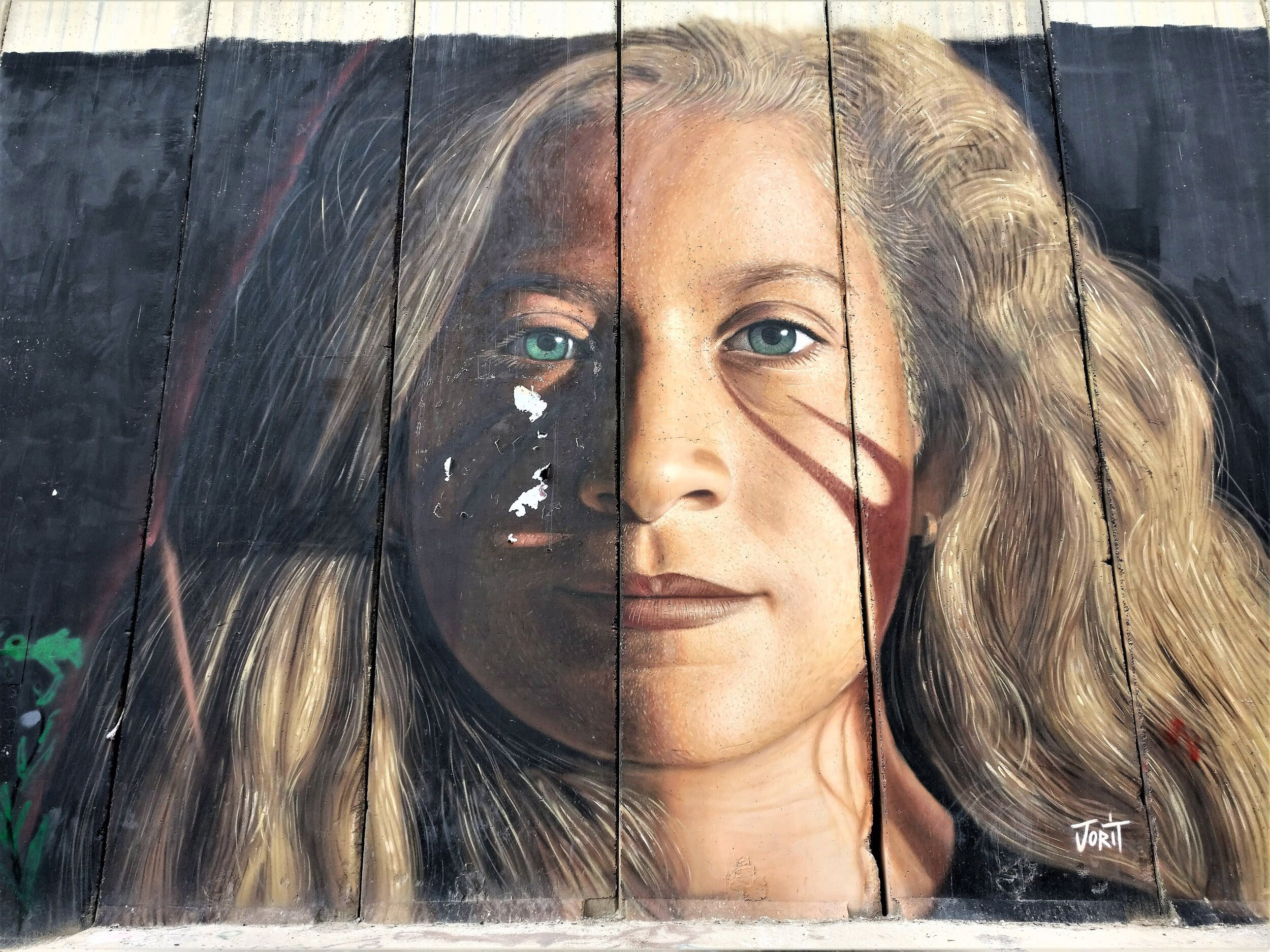 The Wall with a mural of activist   Ahed Tamimi  , who in 2017 was jailed for slapping an Israeli soldier. Italian street artist  Jorit Agoch  was later arrested for deifying Tamimi.