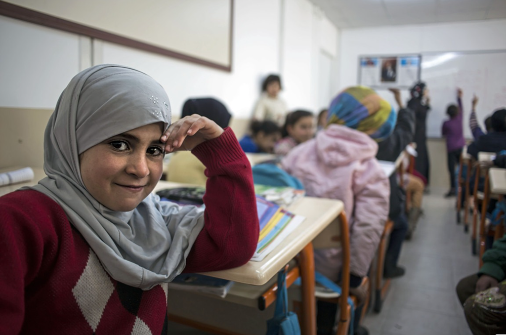 A Syrian girl attends classes at a refugee camp in southern Turkey. 