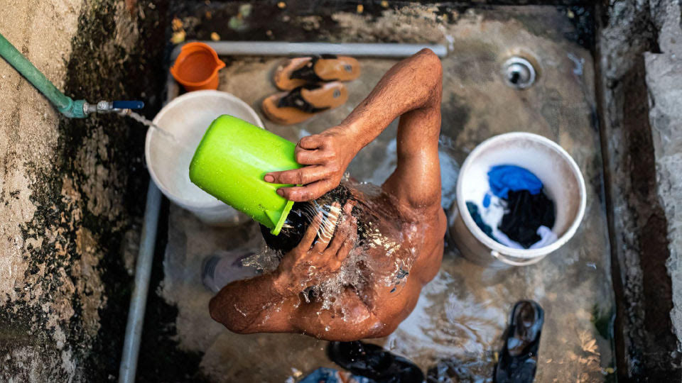A construction worker washes up.