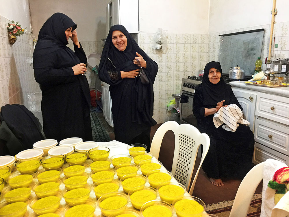8. A family practices nazr, and cooks shole zard, Persian saffron rice pudding, to be freely distributed to people during the holy month of Muharram