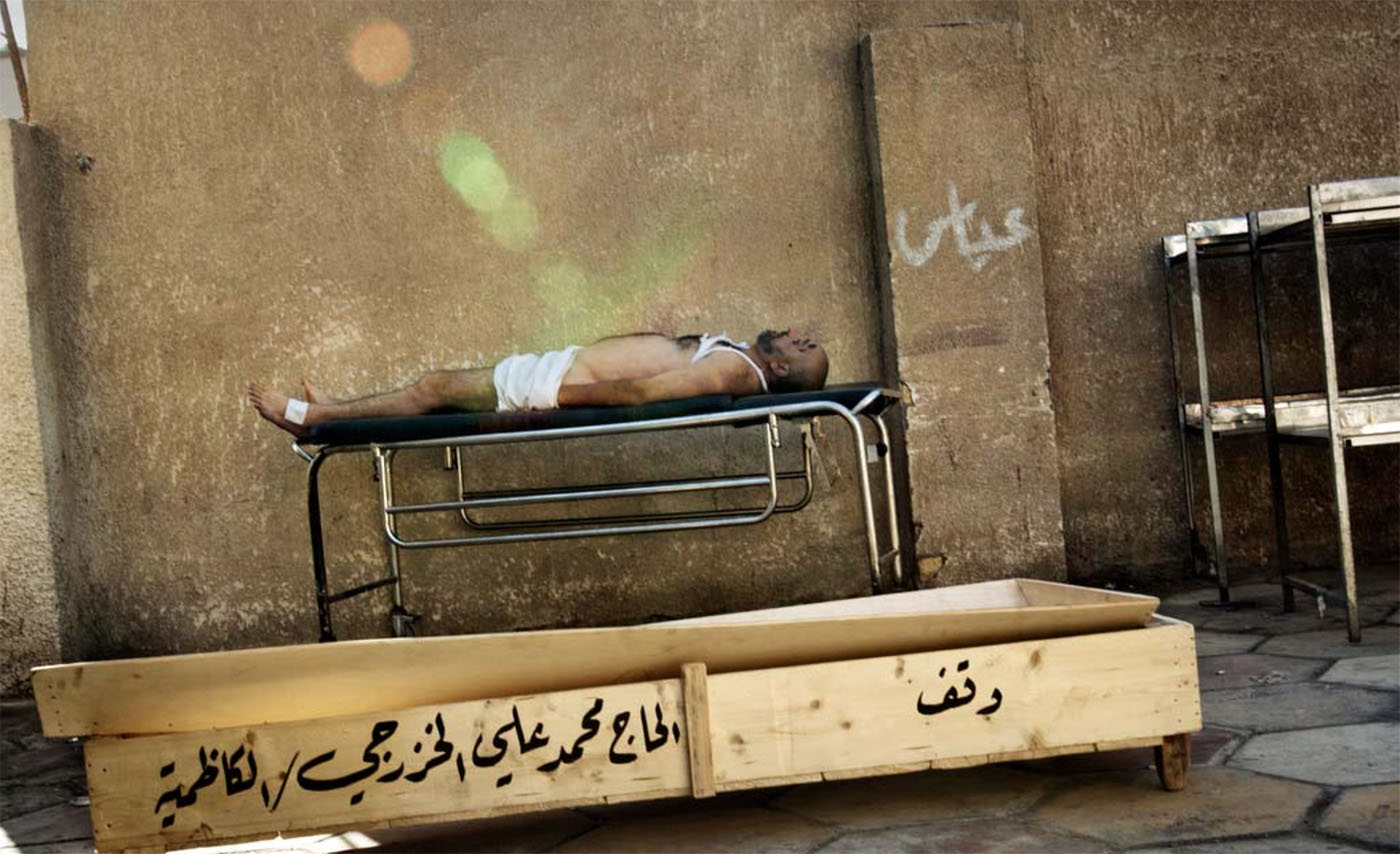 A body rests on a gurney at the Yarmouk hospital morgue in Baghdad, Iraq on July 26, 2006. Photo Franco Pagetti.
