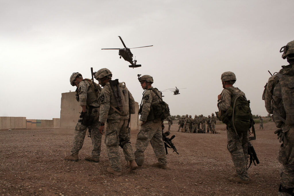 US soldiers in Iraq wait for a helicopter ride photo Jason Mark Schultz