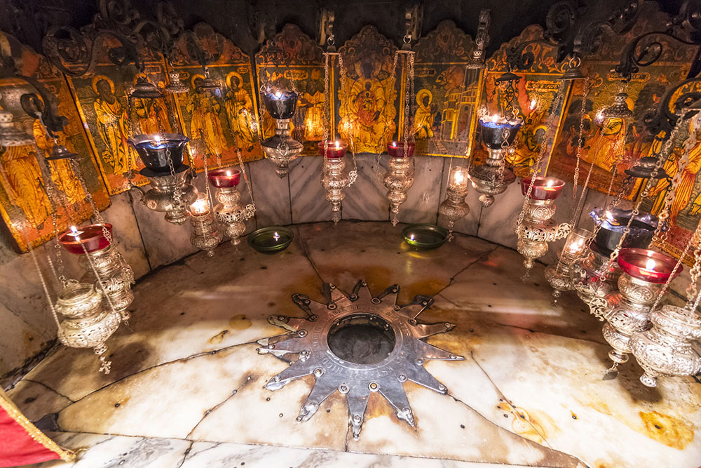A silver star marks the traditional site of Jesus' birth in a cave beneath the Church of the Nativity in Bethlehem, Palestine photo Cezary Wojtkowski