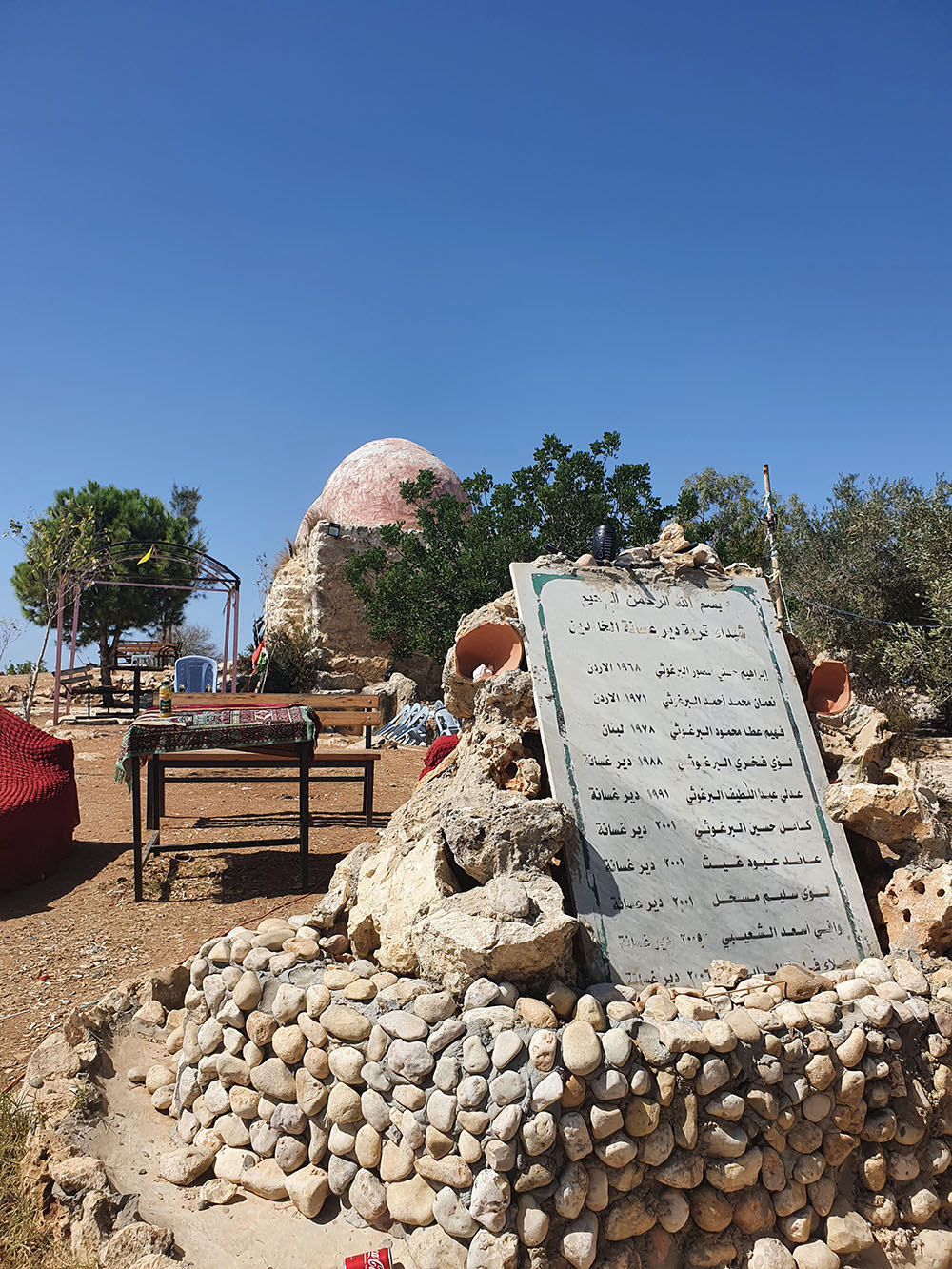 The martyrs’ monument in the park of al-Khawwas with the maqam behind, Deir Ghassaneh.