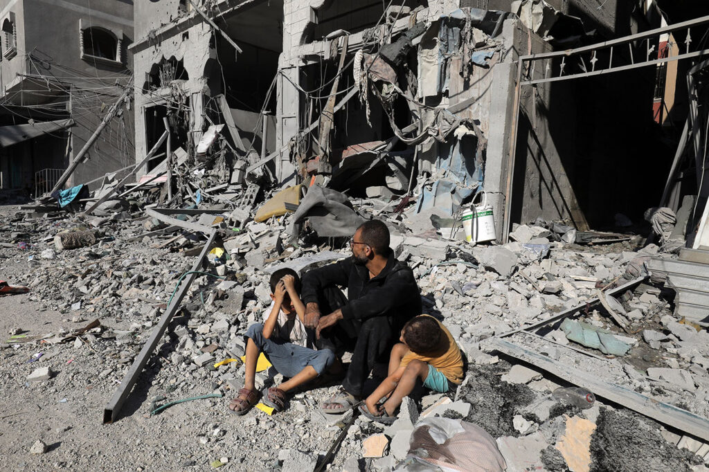 Palestinians search a house after an Israeli air strike in Rafah on October 12, 2023 (photo Anas-Mohammed).
