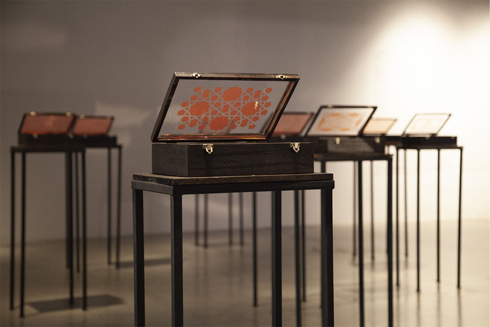 Rushdi Anwar, "We have found in the ashes what we have lost in the ﬁre," mixed medium embedded within 12 wooden boxes, 2011 (installation view, courtesy ab-anbar).