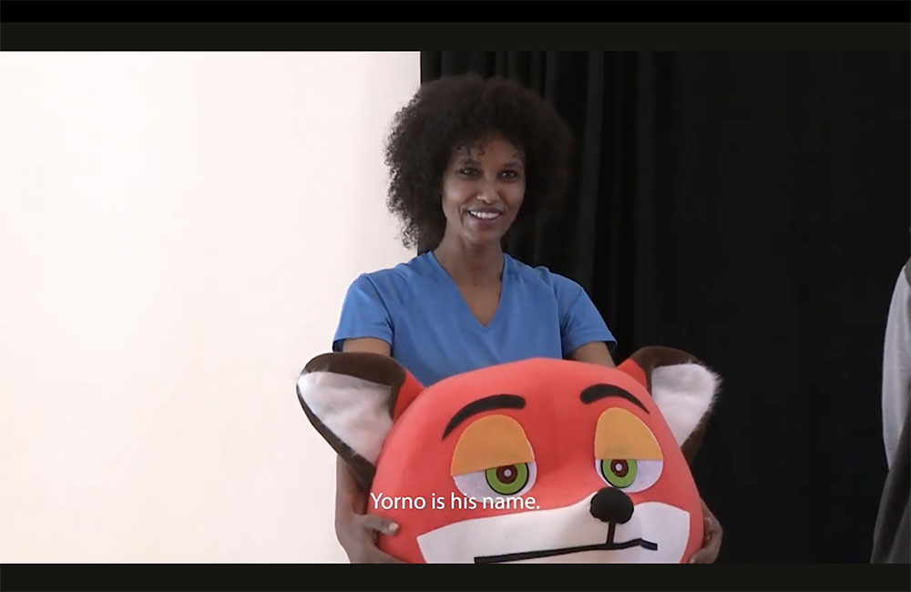 Tima, an Ethiopian woman in Lebanon, who wore a fox costume to be able to see her son.