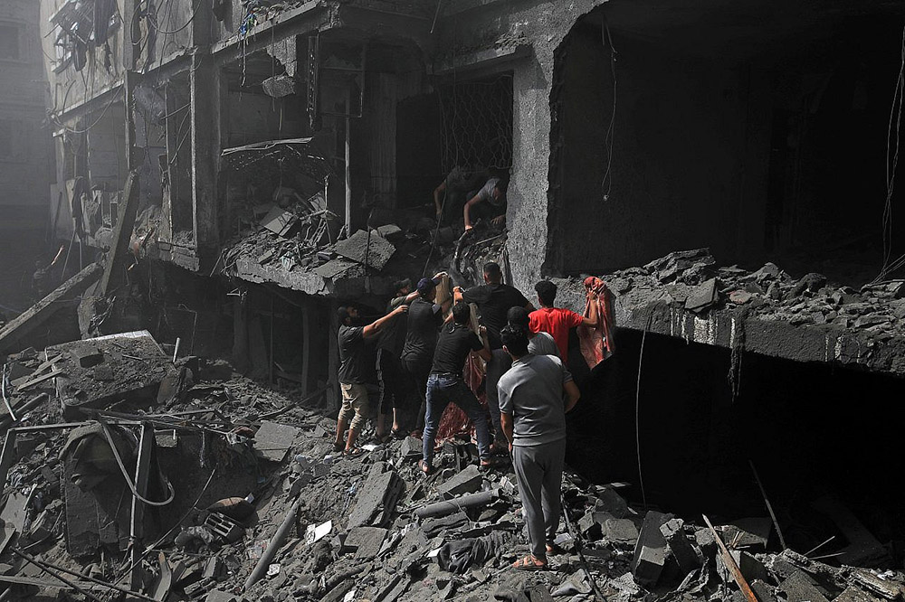 Pulling people from the rubble after massive air strikes in Deir al-Balah, central Gaza, in December. Photo: Mohammed Zaanoun/Activestills