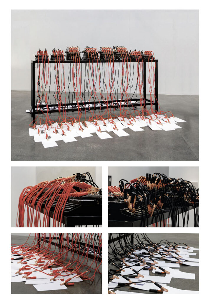 Mounir Fatmi, "Inside the Fire Circle," typewriters, starter cables, papers and table, 140x300x60, 2017, from The Age of Singularity catalogue (courtesy of the artist and Lawrie Shabibi Gallery, Dubai).