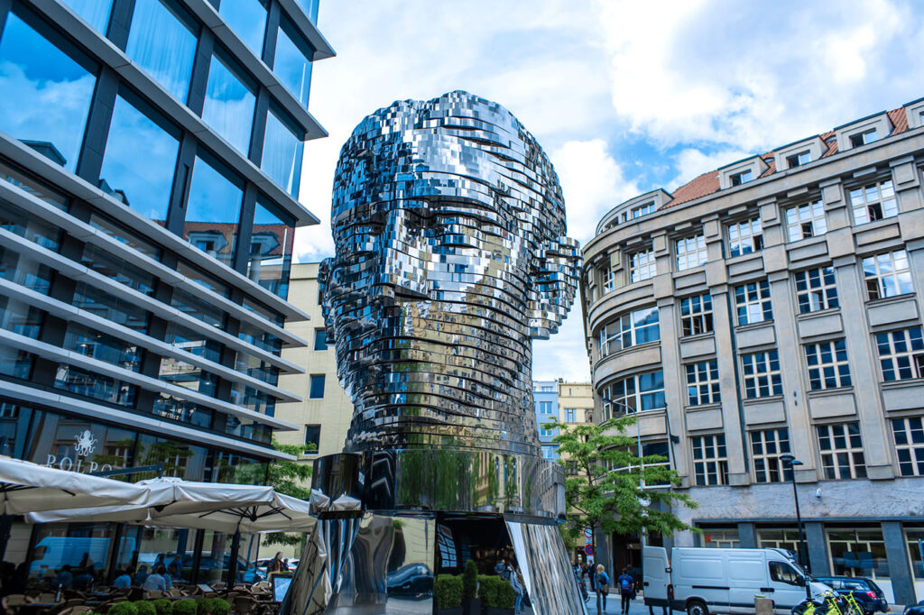 Moving monument head of Franz Kafka, center of Prague. art object chromed shiny sculpture of 64 plates (photo Katerina Kukotae).