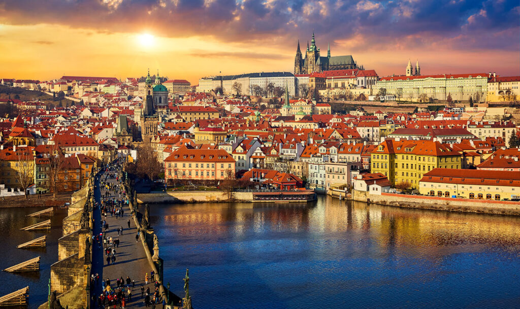 Charles Bridge on the river Vltava, Prague, with the Prague Castle above old town house (photo Yasonya).